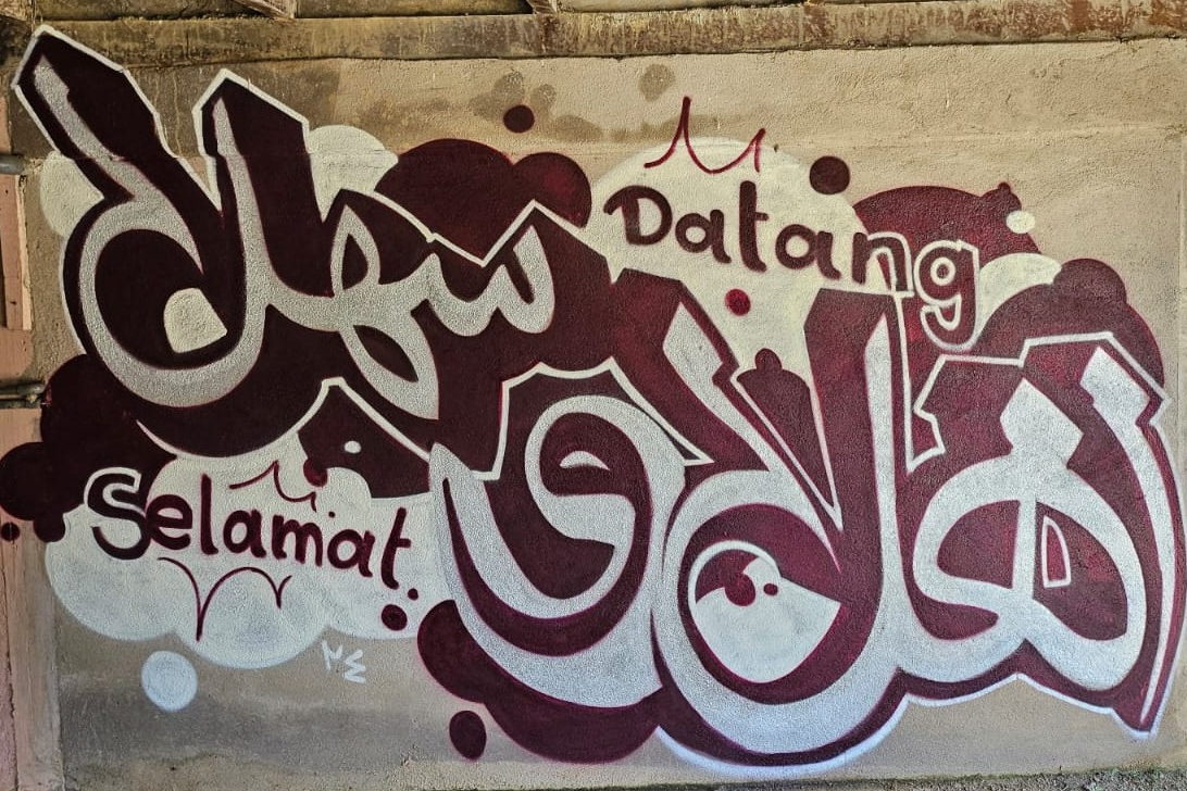 A welcome painted under the porch of a private house