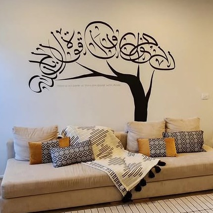 A tree whose canopy is calligraphy, painted on a living-room wall